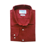 Folded red shirt made from sustainable hemp fabric with a label on a white background