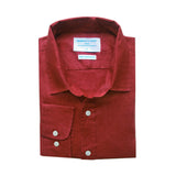 Folded red shirt made from sustainable hemp fabric with a label on a white background