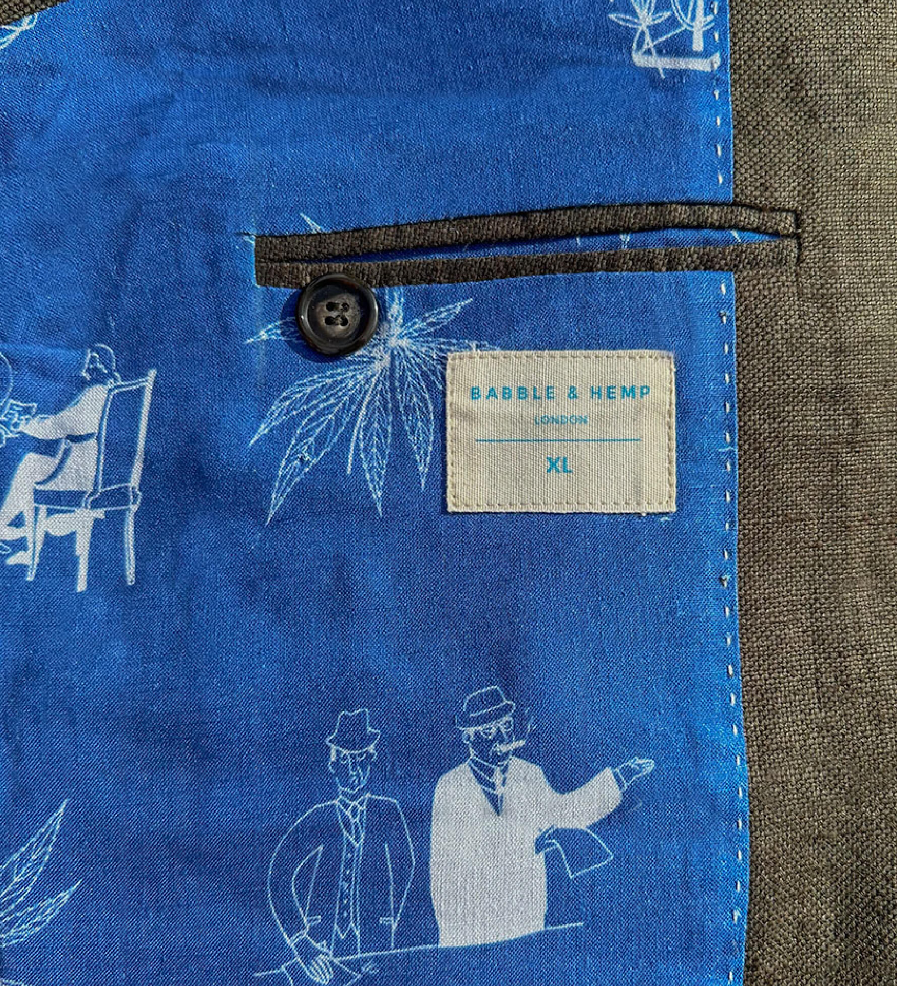Interior lining of blue hemp fabric with white illustrations and a visible brand label on a textured background