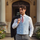 a man wearing a hemp waistcoat which is colour blue with a wooden morning coat draped over his shoulder
