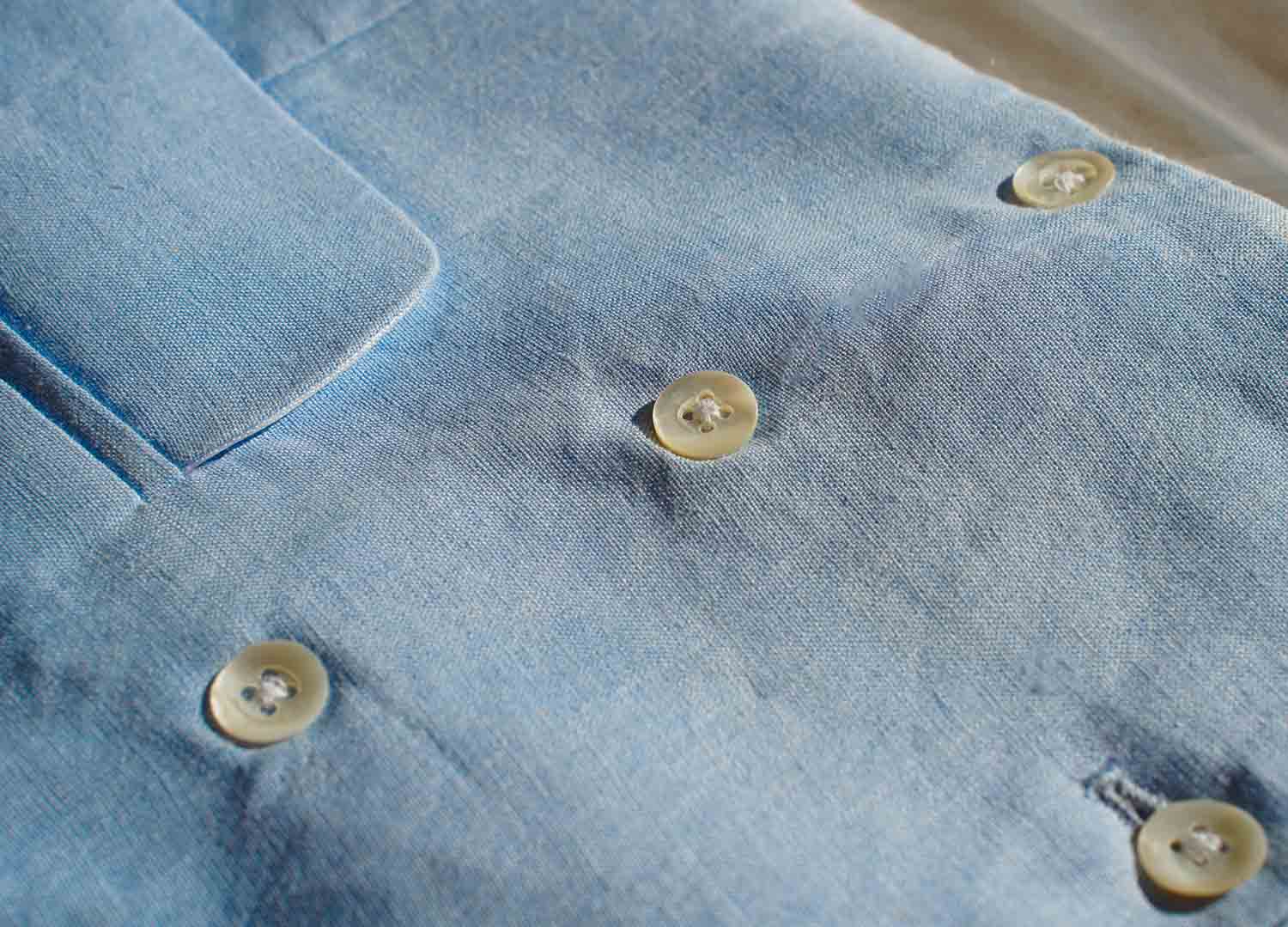 a closeup image of the hemp waistcoat fabric and buttons