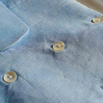 a closeup image of the hemp waistcoat fabric and buttons