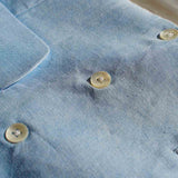 a closeup image of the hemp waistcoat fabric and buttons