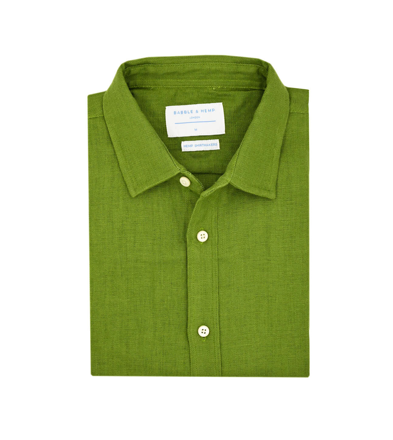 Product shot of folded green hemp shirt with a label on a white background