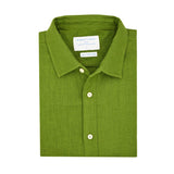 Product shot of folded green hemp shirt with a label on a white background