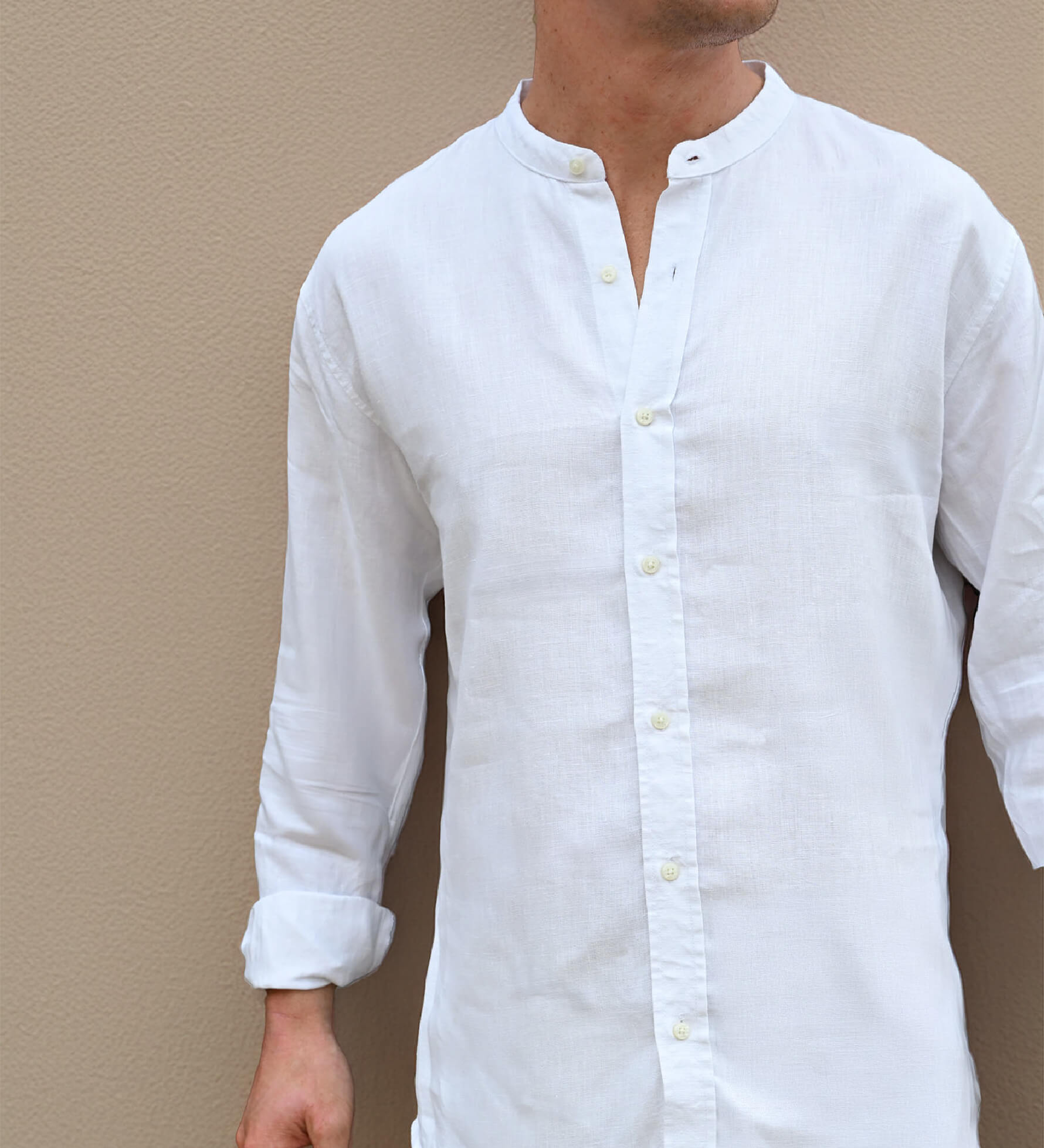 White button-up hemp shirt worn by a person against a beige wall
