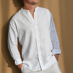 Man wearing a white collarless hemp shirt against a beige background
