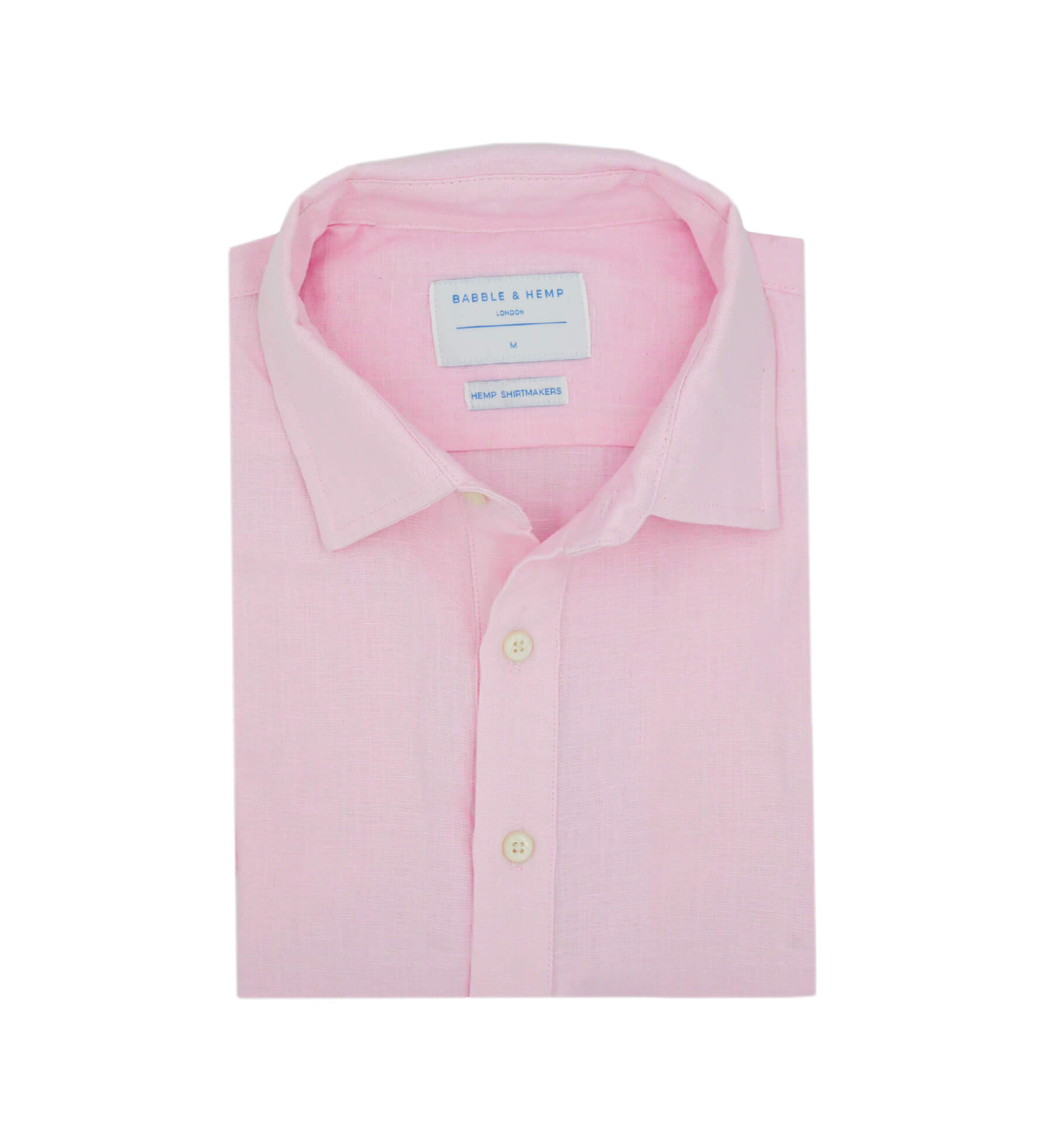 Product shot of neatly folded pink hemp shirt with a label on a white background