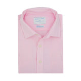 Folded pink dress shirt made from hemp fabric with a label on a white background