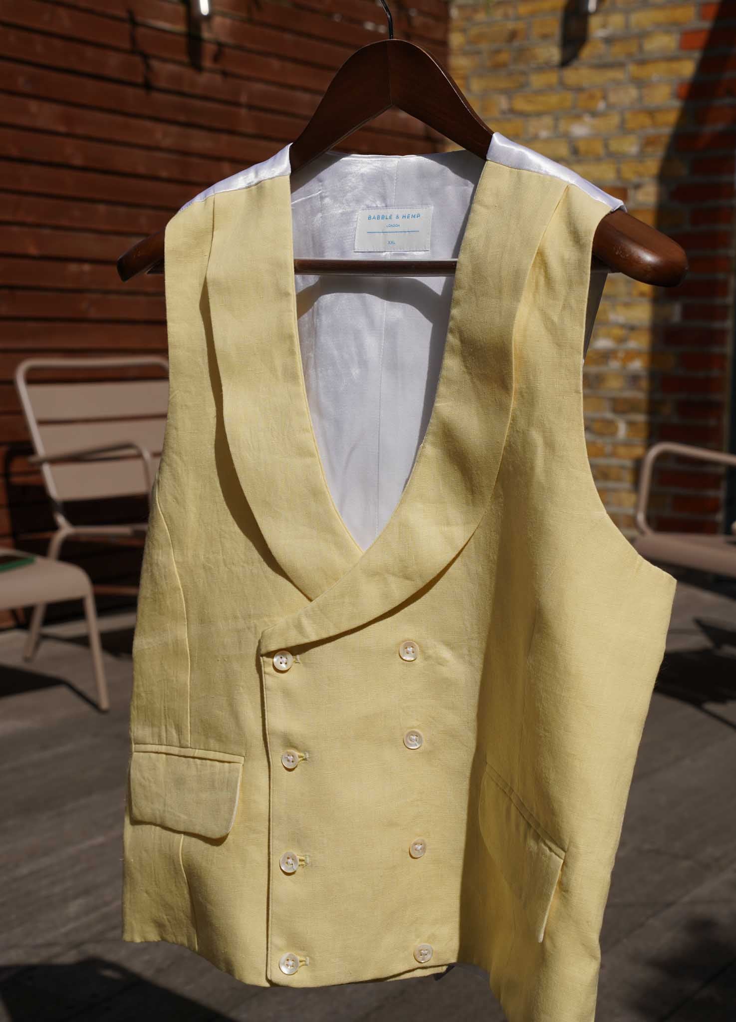 a yellow hemp waistcoat designed for weddings or royal ascot hanging on a washing line