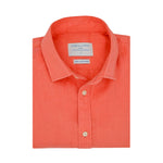 Product photo of a folded coral hemp shirt with a visible label on a white background