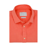 Product photo of a folded coral hemp shirt with a visible label on a white background