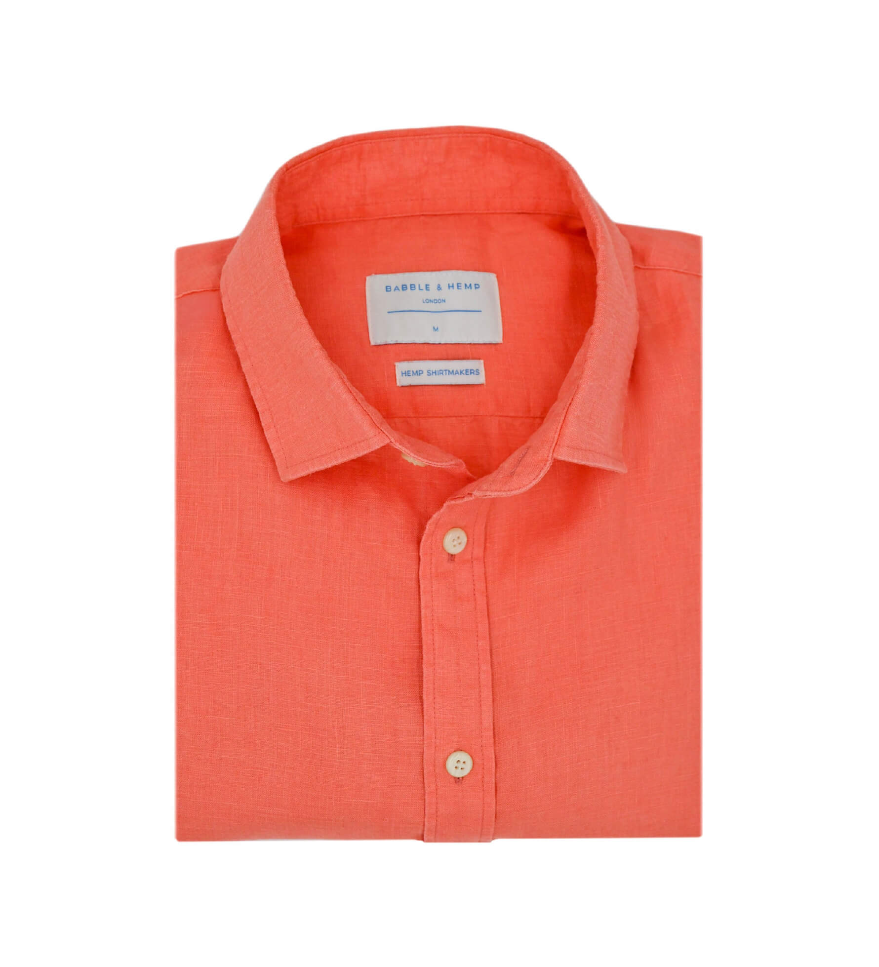 Product photo of a folded coral hemp shirt with a visible label on a white background
