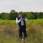 a video showing a man walking in a field shot in slow motion so the viewer can watch how stiff the nehru jacket is and how it behaves with movement