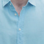 a video demonstrating a model wearing a blue hemp shirt