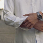 a video of a white hemp shirt as the model wearing it walks down a street