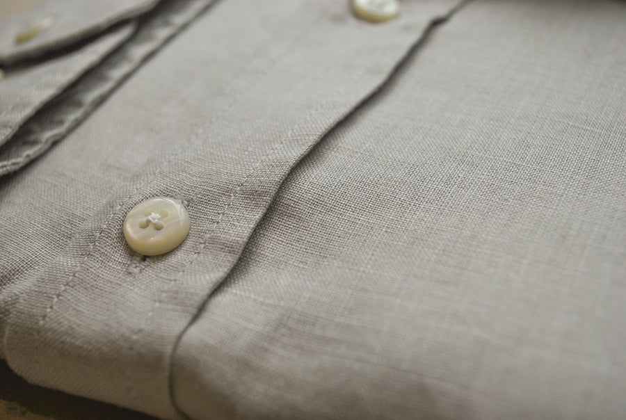 a closeup detail photo of a hemp shirt and the buttons on it