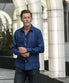 man wears navy blue hemp shirt whilst doing up cuffs