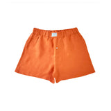 Orange hemp boxer shorts laid flat on a white background