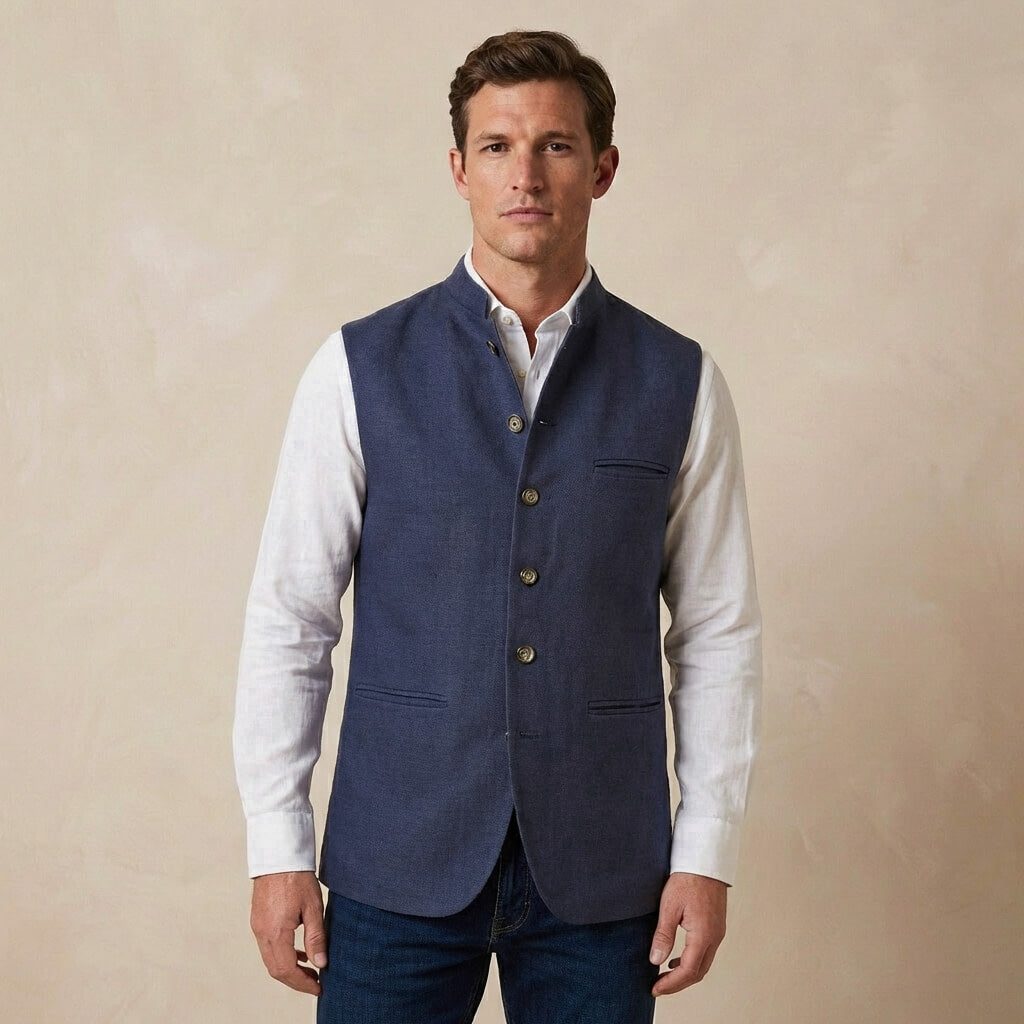 Man wearing a blue nehru gilet made from hemp fabric over a white shirt on a beige background
