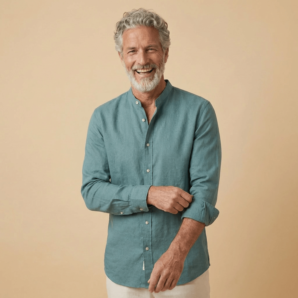 Man wearing a teal coloured hemp fabric shirt with grandad collar against a beige background