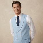 a mid thirties man wearing a light blue coloured double breasted wedding waistcoat made from hemp fabric leans to one side whilst smiling