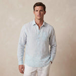 Man wearing a striped light blue and white striped shirt made from hemp fabric against a beige background