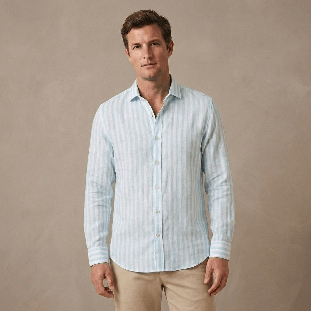 Man wearing a light blue striped shirt made from hemp fabric against a beige background