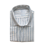 Folded blue and white striped hemp fabric shirt with a label on a white background