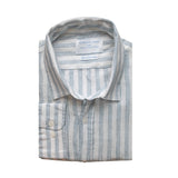 Folded blue and white striped hemp fabric shirt with a label on a white background