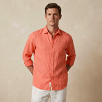 Man wearing a coral hemp shirt against a beige background