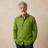 Man wearing a green hemp shirt against a beige background