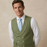 man smiling leans into camera while modelling a green coloured double breasted waistcoat designed for occassionwear such as weddings