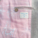 Close-up of a interior lining showing pink and gray textured fabric with a brand label.