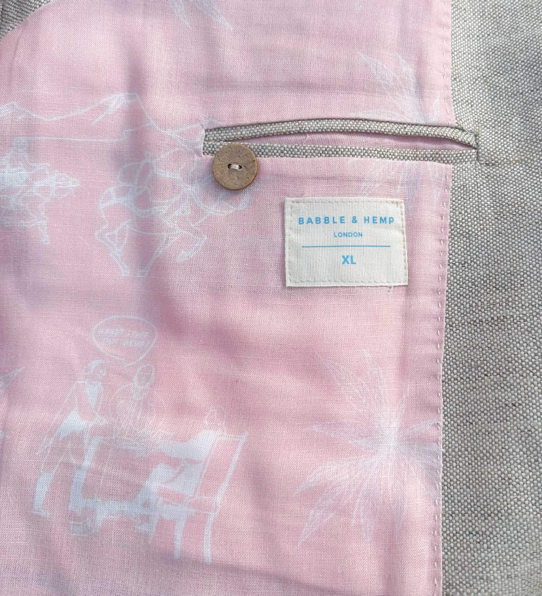 Close-up of a interior lining showing pink and gray textured fabric with a brand label.