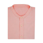 Folded pink collarless hemp shirt on a white background