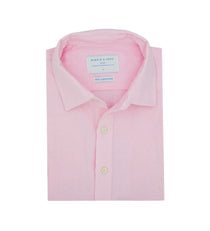 Folded pink dress shirt made from hemp fabric with a label on a white background