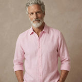 Man wearing a pink hemp shirt which is better than linen against a beige background