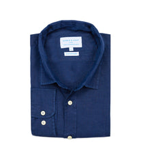 Folded blue shirt of hemp fabric with a visible brand label on a white background