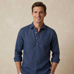 Man wearing a dark blue hemp shirt against a beige background