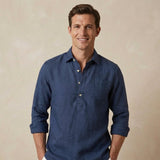 Man wearing a dark blue hemp shirt against a beige background