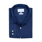 Neatly folded blue hemp shirt with a visible brand label on a white background
