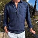Person wearing a blue long-sleeve hemp shirt with a blurred outdoor background