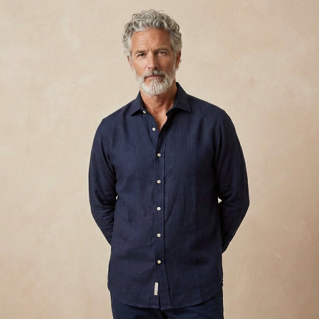 man wears dark navy heavy winter hemp shirt in front of beige backdrop