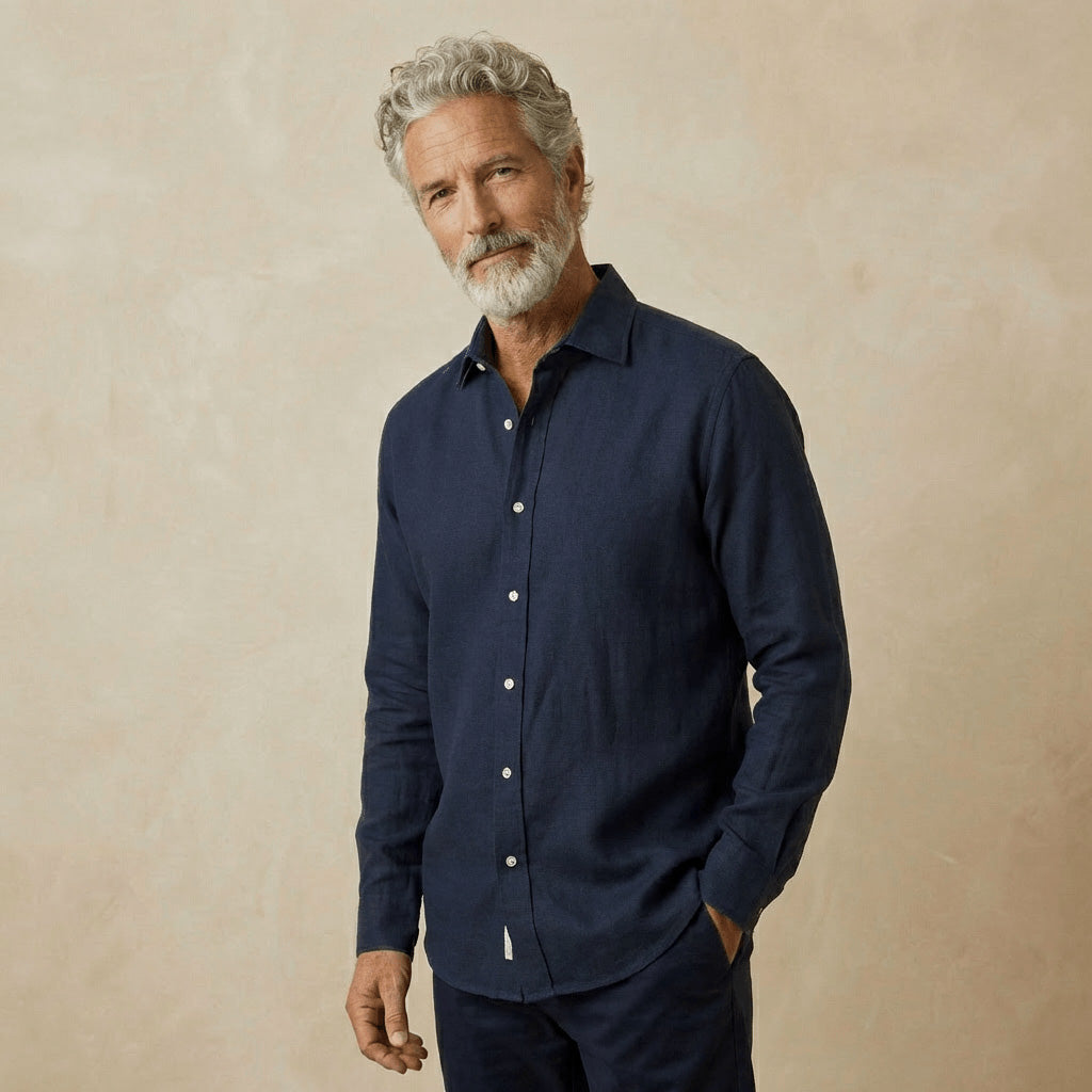 Man wearing a navy blue hemp shirt against a beige background