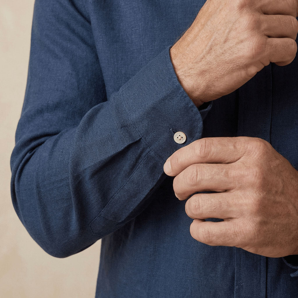 closeup shot of the cuff and button being fastened on a hemp shirt colour navy blue