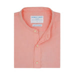 Folded pink hemp shirt with grandad collar and with a label on a white background