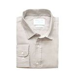 Folded light grey dress shirt with a label on a white background