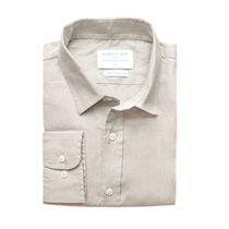 Folded light grey hemp shirt with a collar on a white background