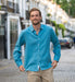 Man wearing a blue shirt made from eco friendly hemp fabric walking outdoors